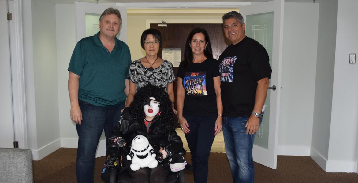 Ralph and partner Tammy pose next to Victoria's parents, who is dressed in full KISS cosplay, during her KISS Tribute Dream