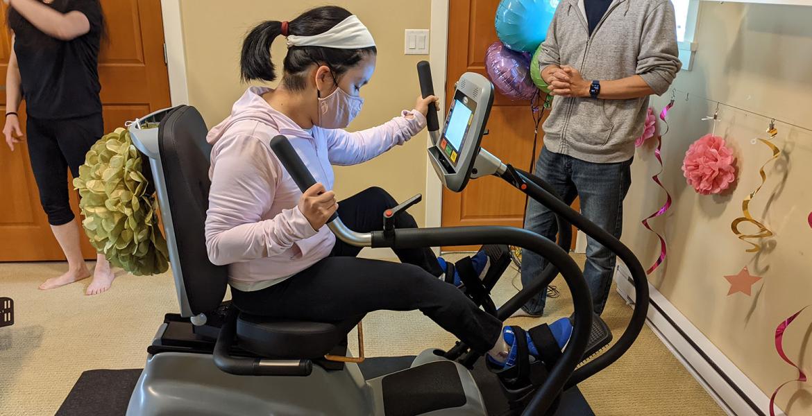 Julia seated in recumbent cross training machine