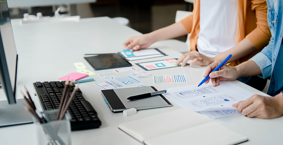 Stock image close up of team working together on paperwork