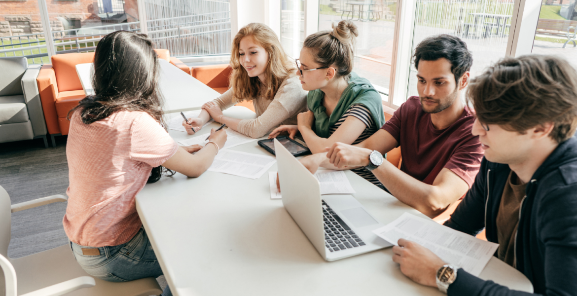 team working together at a table, stock imagery