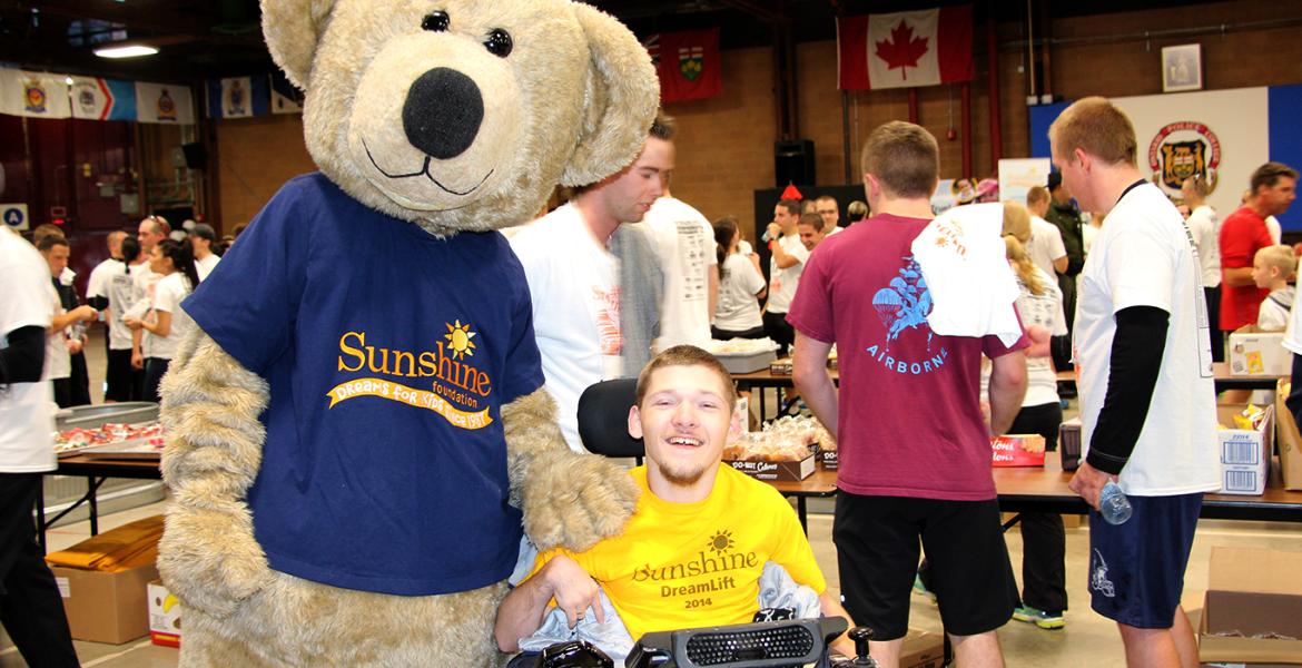 Nathan and Bear mascot smile in front of crowds at Nathan's Garage Sale