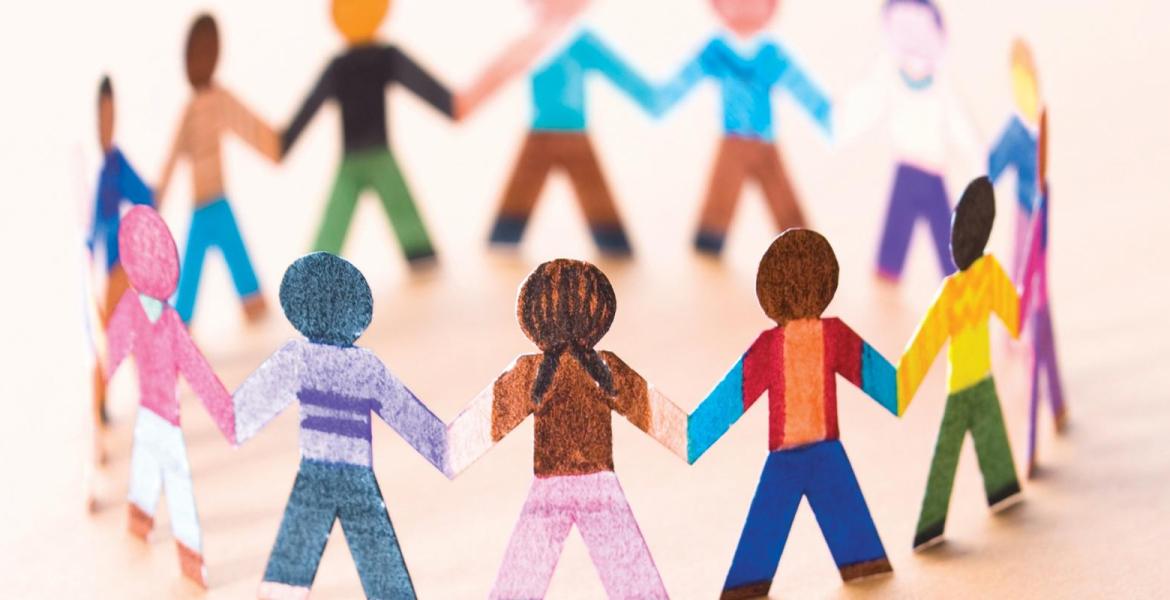 Colourful paper dolls holding hands to form a circle